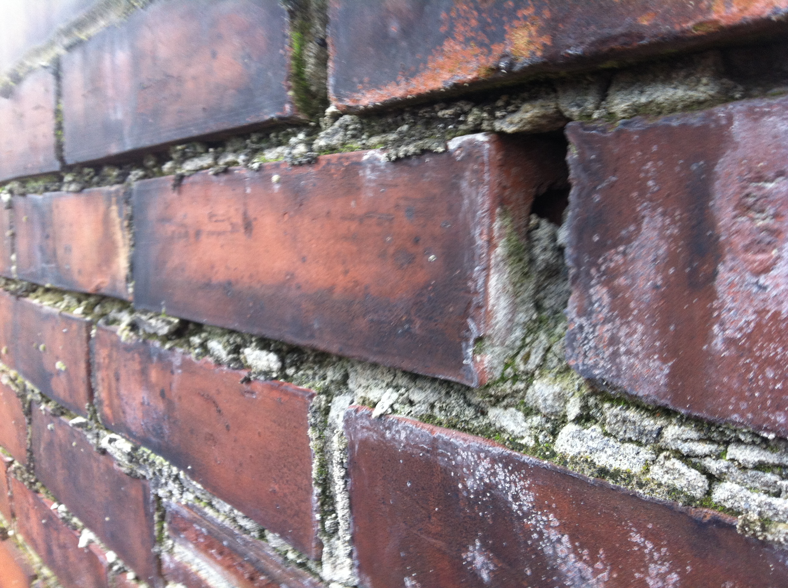 Deteriorating mortar on a brick chimney.