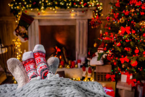 holiday socks in front of decorated fireplace